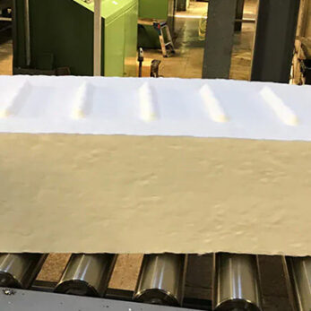 Synthetic rubber bale handling - Rubber bale on conveyor